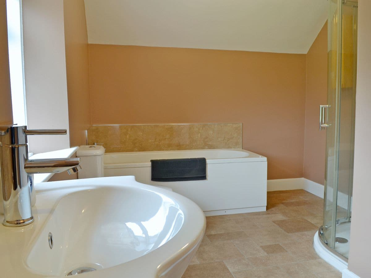 Bathroom with bath and shower cubicle | Halleaths Home Farm, Lochmaben